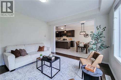 Open concept living space with recessed lighting, dark wood-finish flooring, and a broad window - 11 Esther Crescent, Thorold, ON - Indoor Photo Showing Living Room