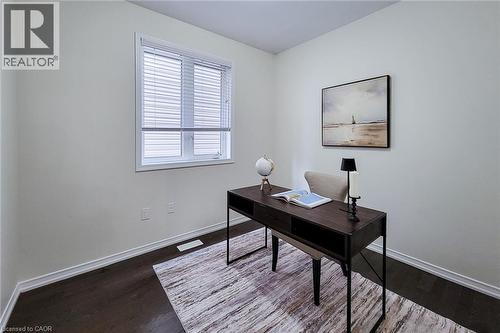 Wood-finish flooring, white trim, and a window with blinds - 11 Esther Crescent, Thorold, ON - Indoor Photo Showing Other Room