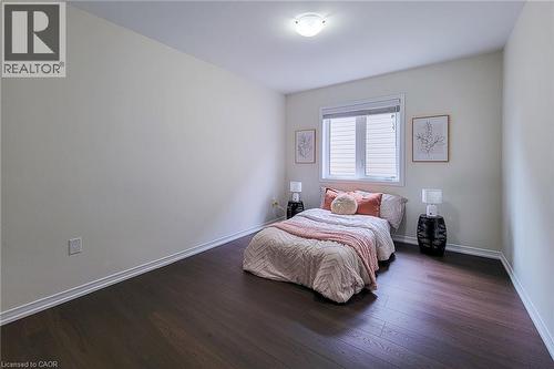 Wood-finish flooring, white trim, recessed window with blinds, and ceiling-mounted light fixture - 11 Esther Crescent, Thorold, ON - Indoor Photo Showing Bedroom