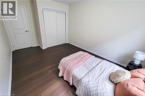 Dark wood-finish flooring with white baseboards - 11 Esther Crescent, Thorold, ON - Indoor Photo Showing Bedroom