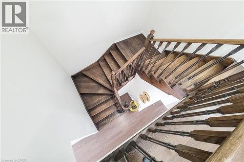 Hardwood staircase with turned balusters, wood handrail, and white walls - 11 Esther Crescent, Thorold, ON - Indoor Photo Showing Other Room