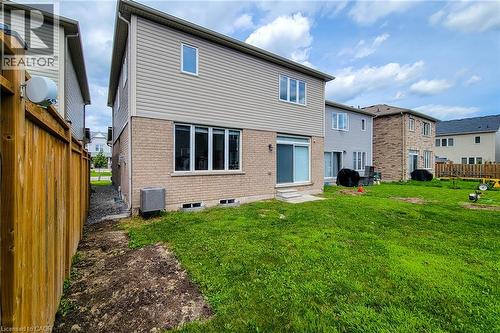 Expansive rear yard with a sliding glass door, a wooden fence, and a brick and siding exterior - 11 Esther Crescent, Thorold, ON - Outdoor With Exterior