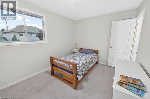 Carpeted flooring, single pane window, white trim, and a white interior door - 43 Liam Drive, Ancaster, ON - Indoor Photo Showing Bedroom