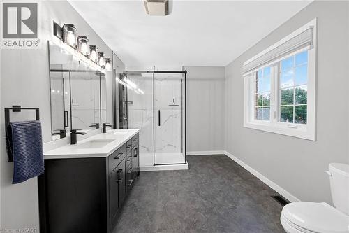 Dual vanity with matte black hardware, frameless mirrors, and contemporary light fixtures - 43 Liam Drive, Ancaster, ON - Indoor Photo Showing Bathroom