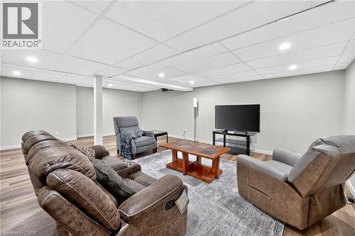 Recessed lighting, light gray walls, wood-finish flooring, and white ceiling panels - 43 Liam Drive, Ancaster, ON - Indoor Photo Showing Basement