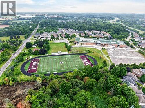 Aerial perspective featuring a track and field stadium, surrounding green spaces, and a nearby building structure - 43 Liam Drive, Ancaster, ON - Outdoor With View