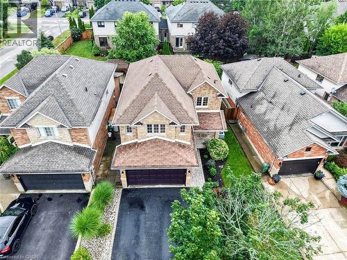 Two-story brick and siding construction with an attached garage, paved driveway, and mature landscaping - 43 Liam Drive, Ancaster, ON - Outdoor