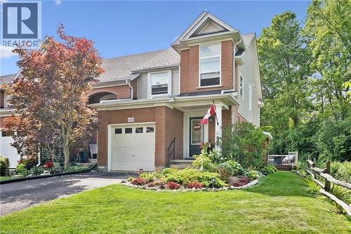 Brick and siding exterior with a gabled roofline, attached single-car garage, and a covered front entry - 439 Beaver Creek Road, Waterloo, ON - Outdoor With Facade