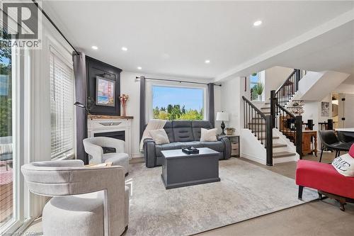 Recessed lighting illuminates an open-concept living area with wood-finish flooring - 439 Beaver Creek Road, Waterloo, ON - Indoor Photo Showing Living Room