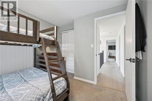 Carpeted flooring, shaker-style closet doors, and light gray wall paint - 439 Beaver Creek Road, Waterloo, ON - Indoor Photo Showing Bedroom