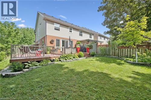 Expansive green lawn with a wooden privacy fence - 439 Beaver Creek Road, Waterloo, ON - Outdoor With Deck Patio Veranda