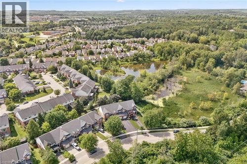 Residential neighborhood featuring a pond, mature trees, and surrounding natural areas - 439 Beaver Creek Road, Waterloo, ON - Outdoor With View