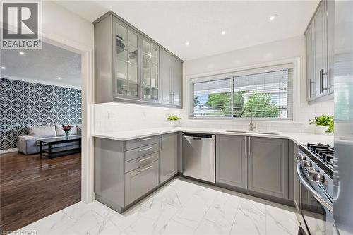 Contemporary kitchen featuring light gray cabinetry, white countertops, stainless steel appliances, and a white subway tile backsplash - 49 East Street, Cambridge, ON - Indoor Photo Showing Kitchen With Upgraded Kitchen