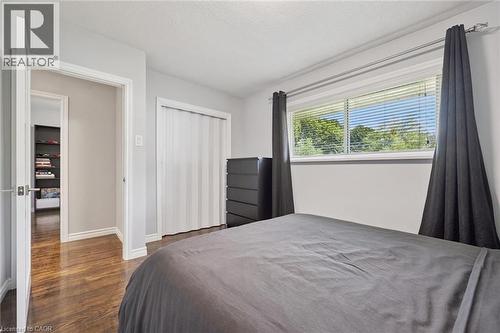 Wood-finish flooring, white trim, and a horizontal window with blinds - 49 East Street, Cambridge, ON - Indoor Photo Showing Bedroom