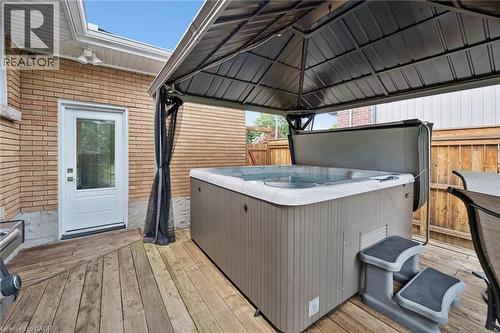Wood-finish deck with a built-in hot tub, covered by a permanent gazebo structure - 49 East Street, Cambridge, ON - Outdoor With Deck Patio Veranda With Exterior