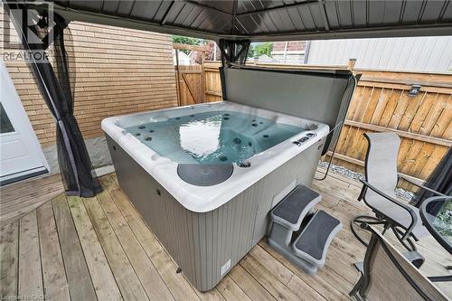 Outdoor hot tub with steps situated on a wood-finish deck - 49 East Street, Cambridge, ON - Outdoor With Deck Patio Veranda With Exterior