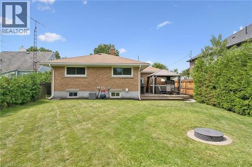 Brick exterior, wood deck, fenced perimeter, established privacy hedging, and an in-ground fire pit - 49 East Street, Cambridge, ON - Outdoor With Deck Patio Veranda