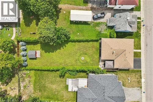 Expansive grassy yard with mature trees and a detached storage shed - 49 East Street, Cambridge, ON - Outdoor With View