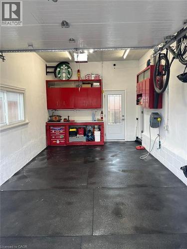 Garage space with modular floor tiling, built-in storage cabinetry, and overhead lighting - 49 East Street, Cambridge, ON - Indoor Photo Showing Garage