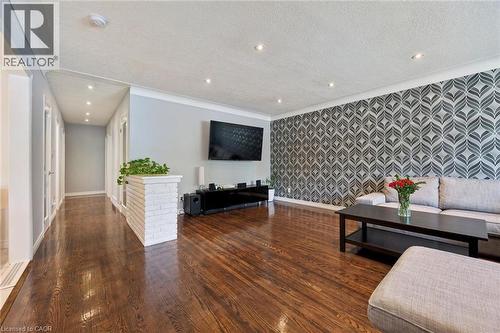 Hardwood flooring throughout, recessed ceiling lighting, decorative accent wall, and crown molding - 49 East Street, Cambridge, ON - Indoor