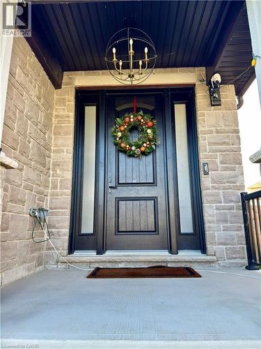 Stone veneer facade with a concrete porch - 923 Eaglecrest Court, Kitchener, ON - Outdoor With Exterior