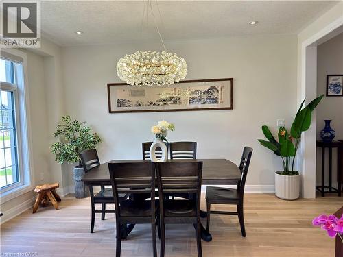 Recessed ceiling lighting, a decorative chandelier, and light wood-finish flooring - 923 Eaglecrest Court, Kitchener, ON - Indoor Photo Showing Dining Room