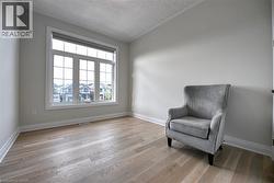Expansive window with white trim, wood-finish flooring, and light-toned walls - 