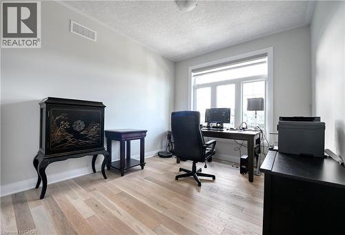Wood-finish flooring with a large window and white trim - 923 Eaglecrest Court, Kitchener, ON - Indoor Photo Showing Office
