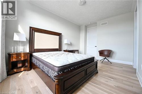Light wood-finish flooring with crisp white walls - 923 Eaglecrest Court, Kitchener, ON - Indoor Photo Showing Bedroom