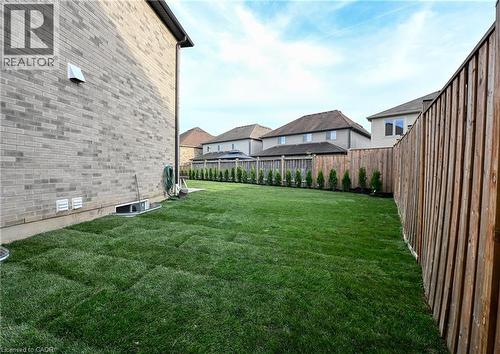Expansive backyard featuring freshly laid sod and a privacy fence - 923 Eaglecrest Court, Kitchener, ON - Outdoor