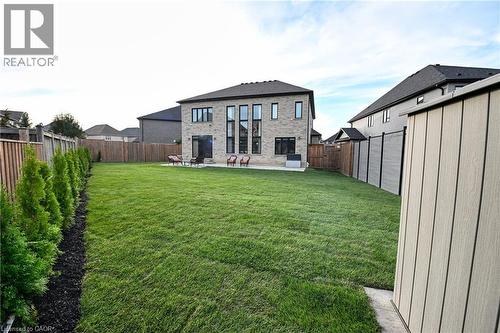 Expansive green lawn with mature evergreen plantings - 923 Eaglecrest Court, Kitchener, ON - Outdoor