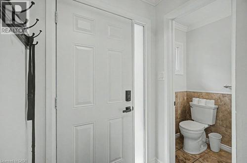 Panel door with frosted glass side-light and smart lock - 2050 Upper Middle Road Unit# 164, Burlington, ON - Indoor Photo Showing Bathroom