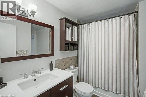 Vanity with an integrated rectangular sink and polished chrome faucet - 2050 Upper Middle Road Unit# 164, Burlington, ON - Indoor Photo Showing Bathroom