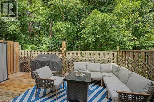Expansive wood deck with privacy fencing and lush mature trees - 2050 Upper Middle Road Unit# 164, Burlington, ON - Outdoor With Deck Patio Veranda