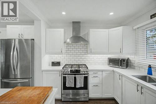 White shaker cabinetry, stainless steel appliances, subway tile backsplash, white countertops, and recessed lighting - 2050 Upper Middle Road Unit# 164, Burlington, ON - Indoor Photo Showing Kitchen With Upgraded Kitchen