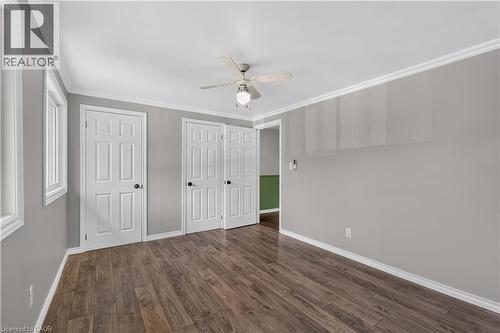 Wood-finish flooring, white trim, recessed windows, multiple panel doors, and a ceiling fan with integrated lighting - 66 Summercrest Drive Unit# 3, Hamilton, ON - Indoor Photo Showing Other Room