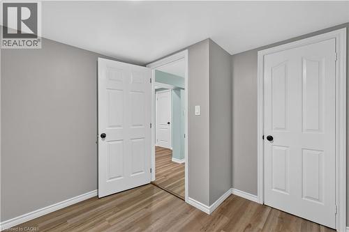 Wood-finish flooring with white trim and light gray walls - 66 Summercrest Drive Unit# 3, Hamilton, ON - Indoor Photo Showing Other Room