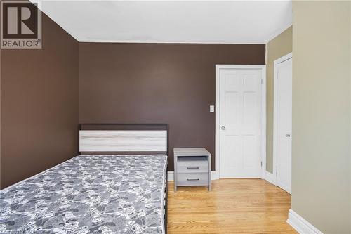 Wood-finish flooring with a neutral wall palette - 185 Burlington Street, London, ON - Indoor Photo Showing Bedroom