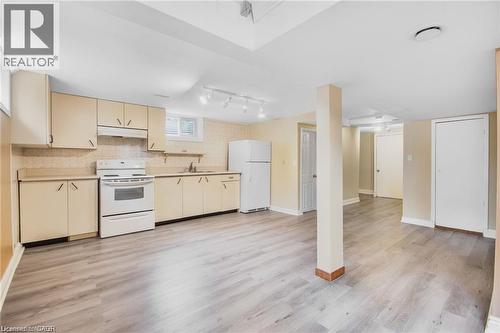 Kitchen area featuring wood-finish flooring, light-toned cabinetry, and white appliances - 185 Burlington Street, London, ON - Indoor Photo Showing Kitchen