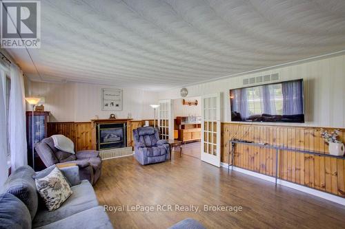 7287 Wellington Rd 109, Mapleton, ON - Indoor Photo Showing Living Room With Fireplace