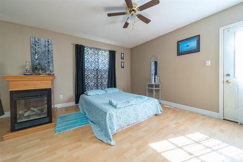 39003 Uppingham Road, Anola, MB - Indoor Photo Showing Bedroom With Fireplace