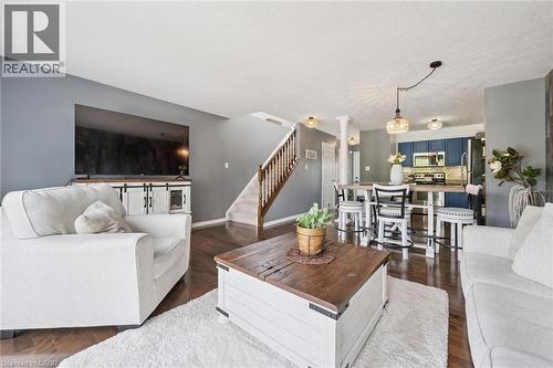Hardwood flooring throughout, a staircase with wood banister, and recessed lighting - 308 Parkvale Drive, Kitchener, ON - Indoor Photo Showing Living Room