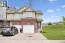 Brick and siding exterior with an attached garage, a paved driveway, and a covered porch - 308 Parkvale Drive, Kitchener, ON  - Outdoor With Facade 