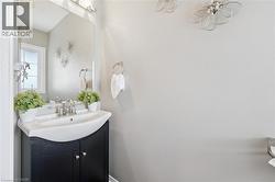 Black vanity with a white integrated sink, chrome faucet, and rectangular wall mirror - 