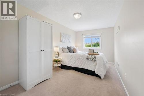Recessed window, white painted walls, ceiling-mounted light fixture, light-colored carpet flooring - 308 Parkvale Drive, Kitchener, ON - Indoor Photo Showing Bedroom