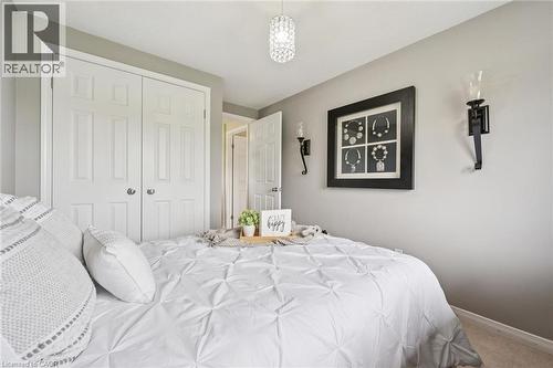 Double-door closet with paneling and chrome hardware - 308 Parkvale Drive, Kitchener, ON - Indoor Photo Showing Bedroom