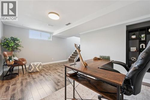 Spacious room with wood-finish flooring, built-in shelving, and a recessed window - 308 Parkvale Drive, Kitchener, ON - Indoor