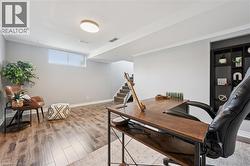 Spacious room with wood-finish flooring, built-in shelving, and a recessed window - 