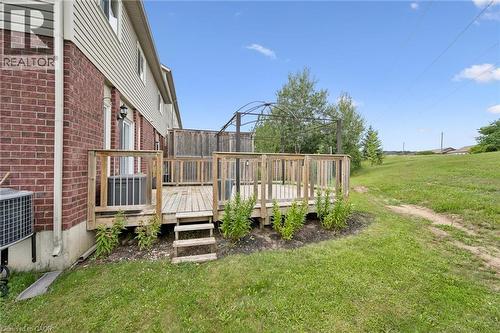 Wood deck with railing and steps, exterior brick and siding, and expansive grassy area - 308 Parkvale Drive, Kitchener, ON - Outdoor