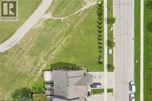 Gabled roofline, asphalt shingle roofing, paved driveway, concrete sidewalks, and a manicured lawn - 308 Parkvale Drive, Kitchener, ON -  With View